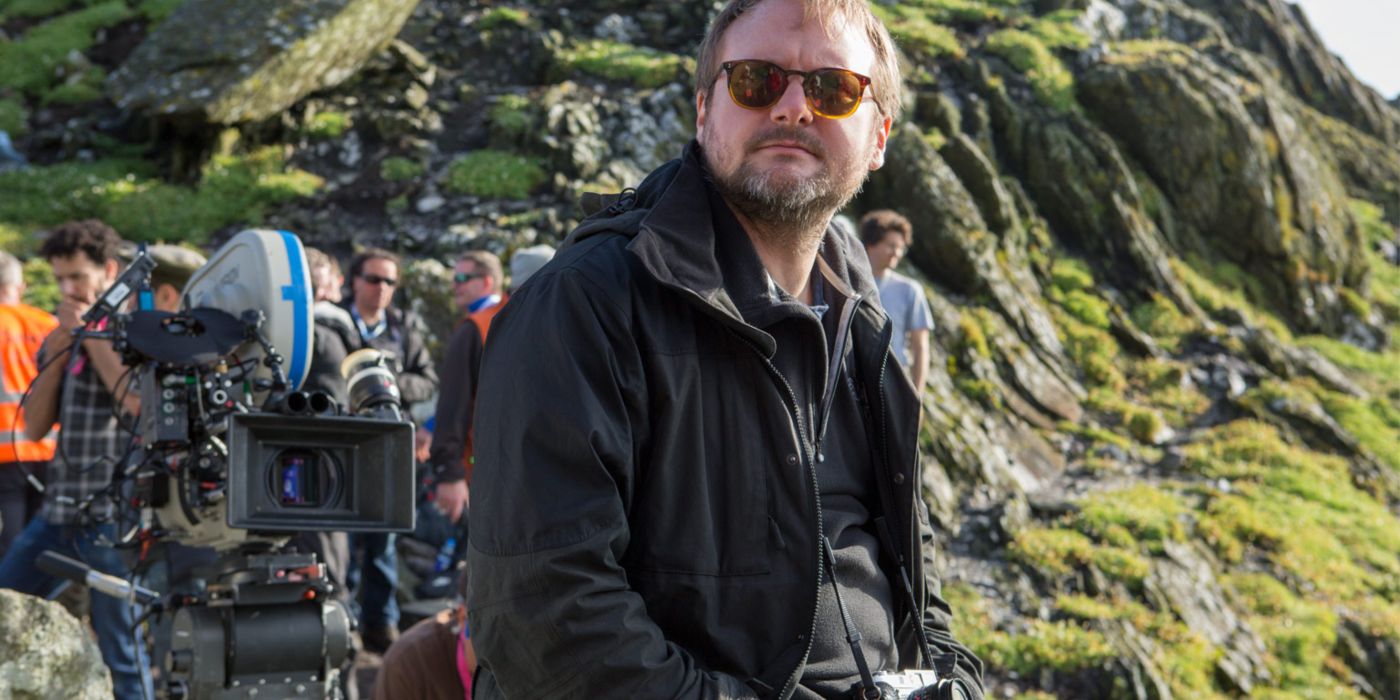 Rian Johnson filming on set against a backdrop of moss-covered stone