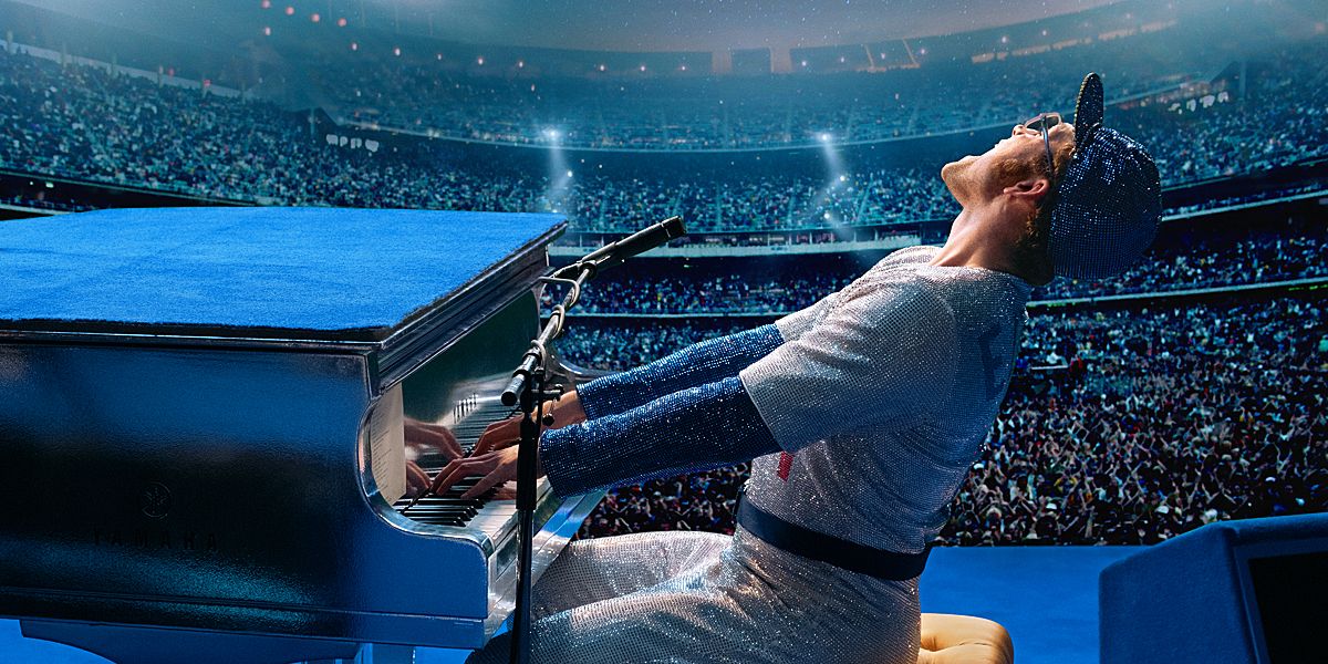 Elton John on stage at a piano