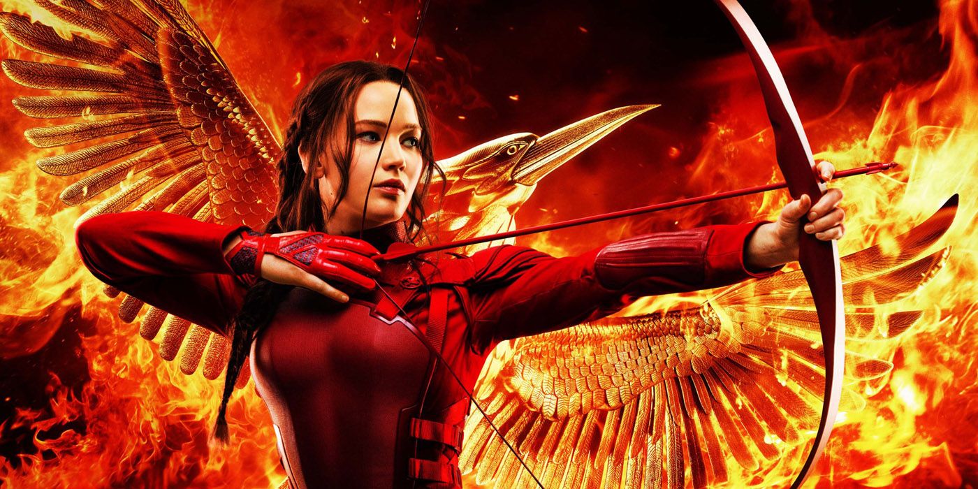 Katniss aims her arrow with a fiery mockingjay behind her in The Hunger Games: Mockingjay - Part 2 poster
