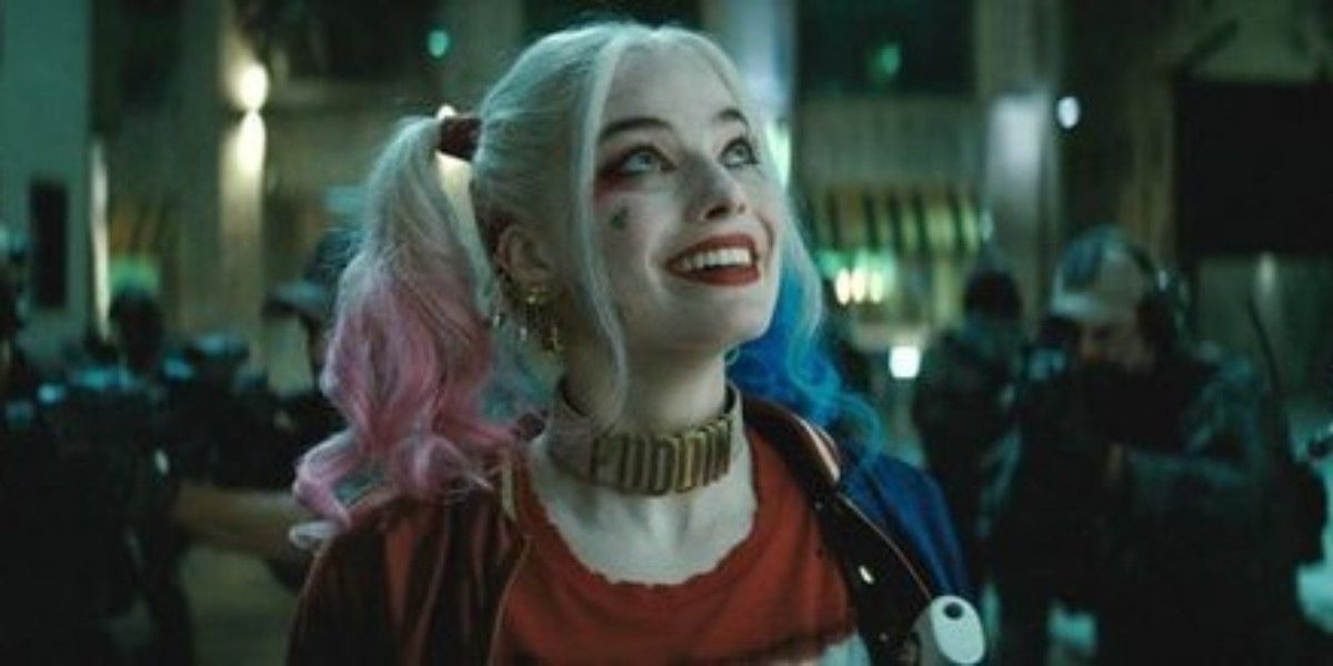 Harley Quinn (Margot Robbie) smiling even as armed soldiers surround her in Suicide Squad