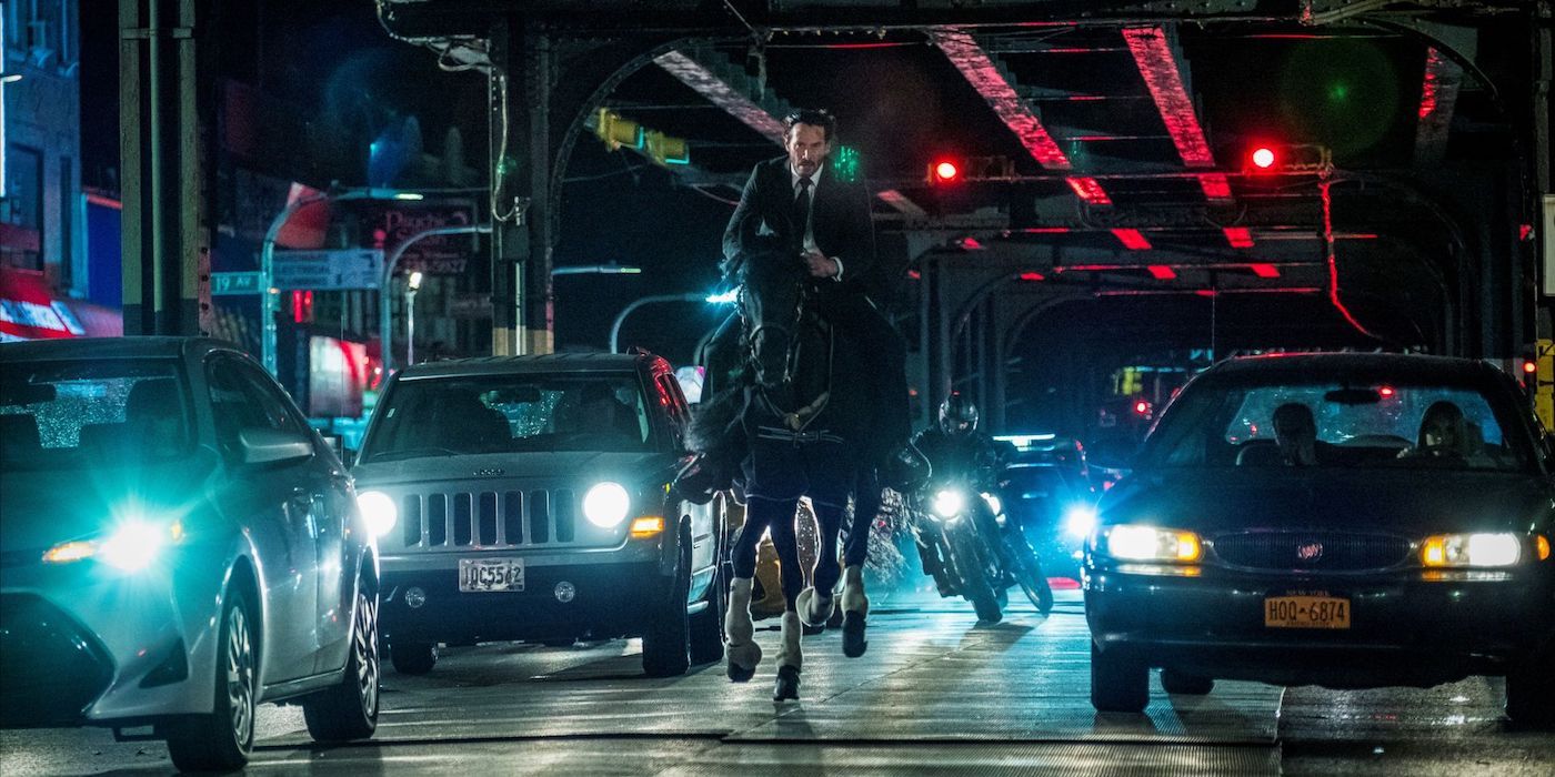 John Wick riding a horse on a busy road in the John Wick series