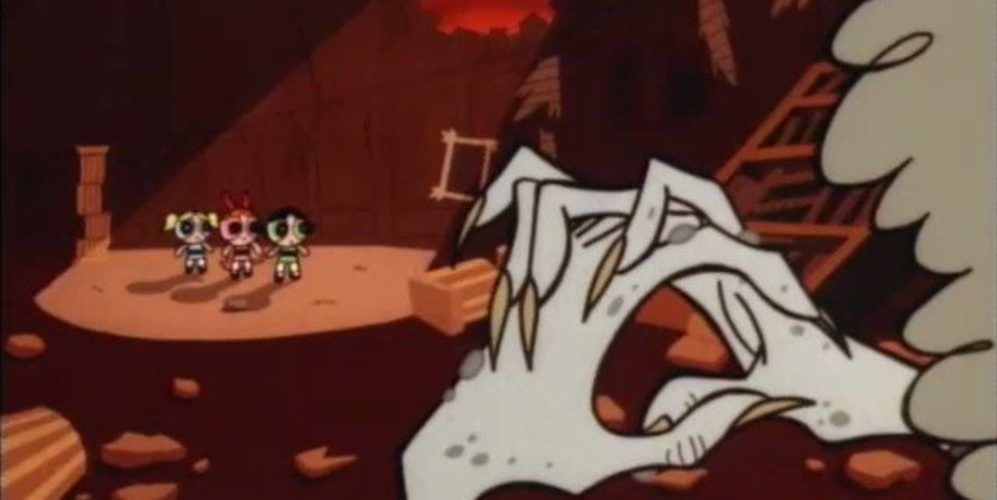 The Powerpuff Girls stand scared in the distance with a pair of grey zombie hands in the foreground