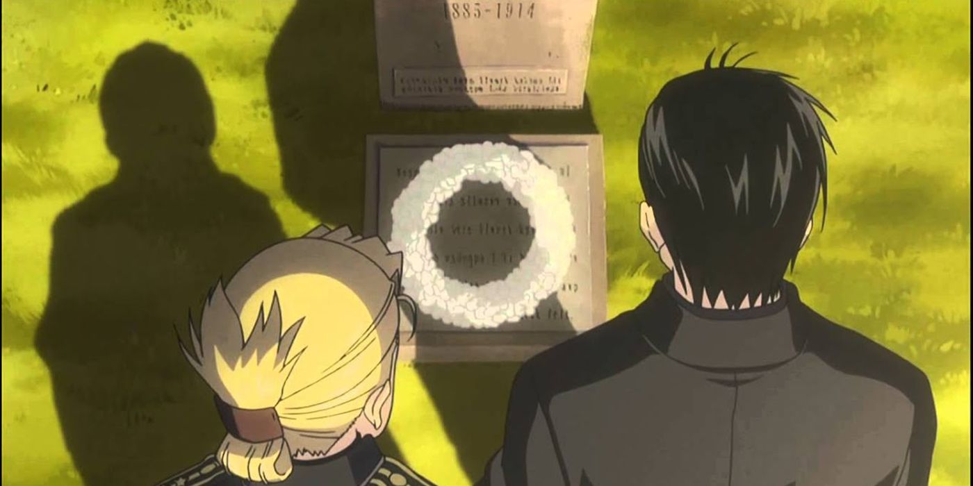Riza Hawkeye and Roy Mustang standing at the grave of Maes Hughes in Fullmetal Alchemist Brotherhood