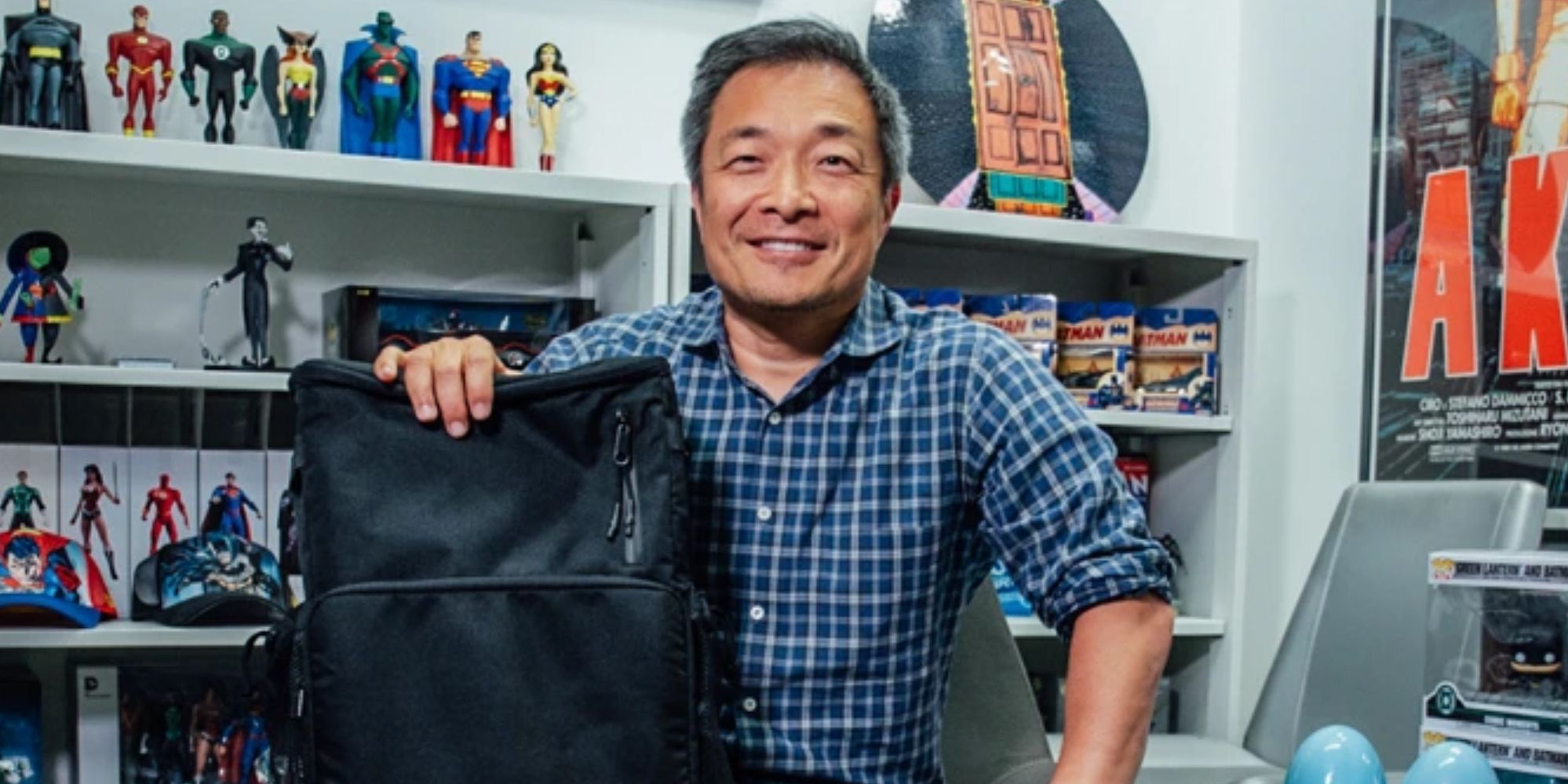 Jim Lee smiling with a backpack