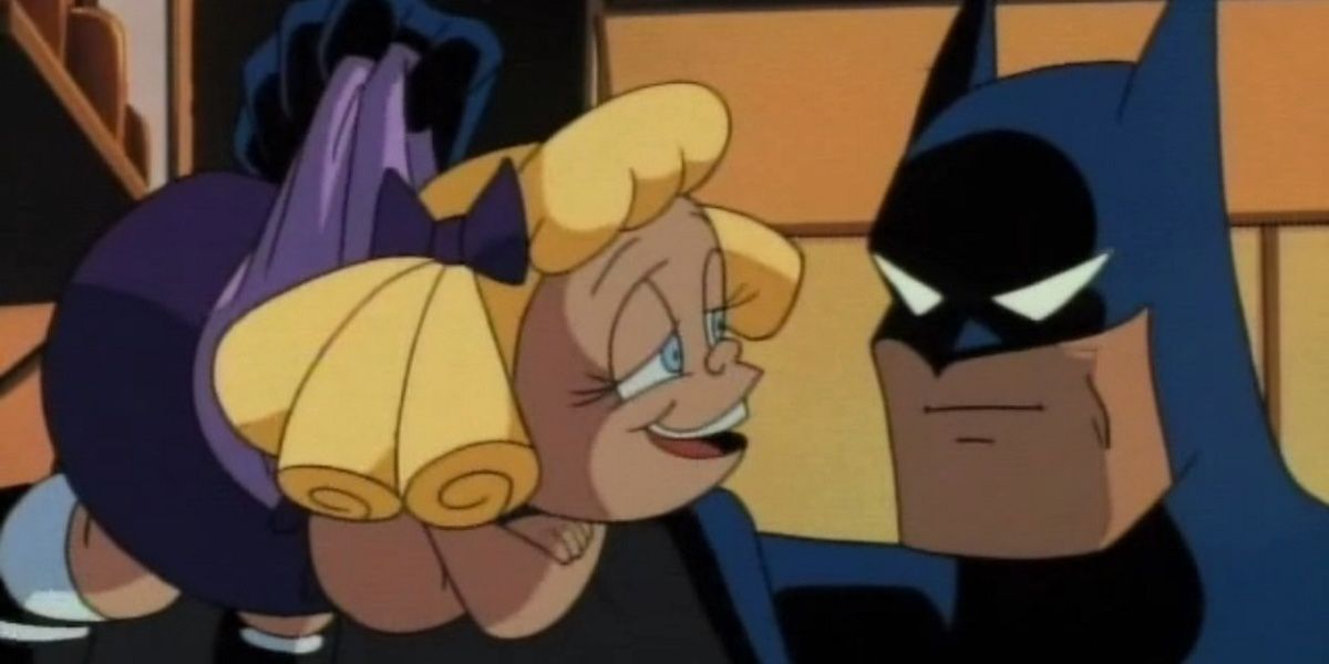 Batman segura uma boneca derrotada