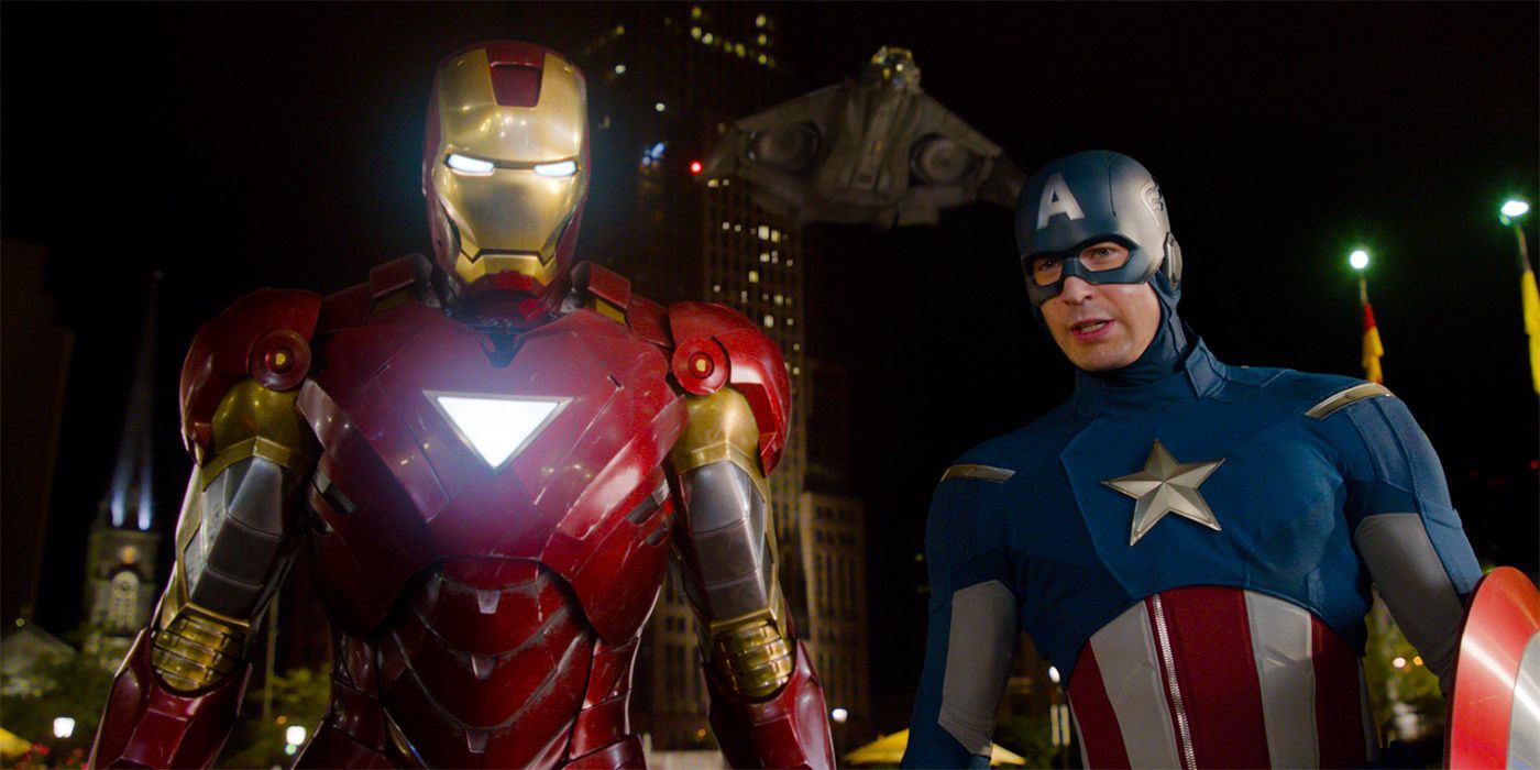 Iron Man and Captain America stand over Loki