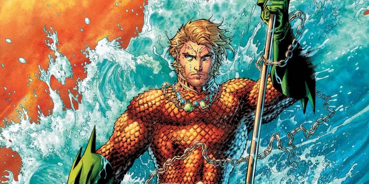 Aquaman holding his trident as the waves crash behind him in DC Comics