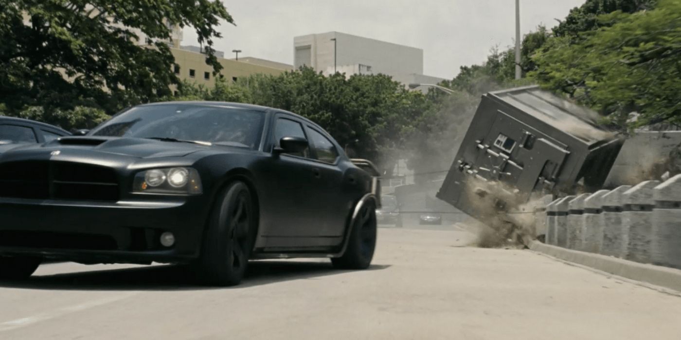 A car drags a safe during a heist in Fast Five
