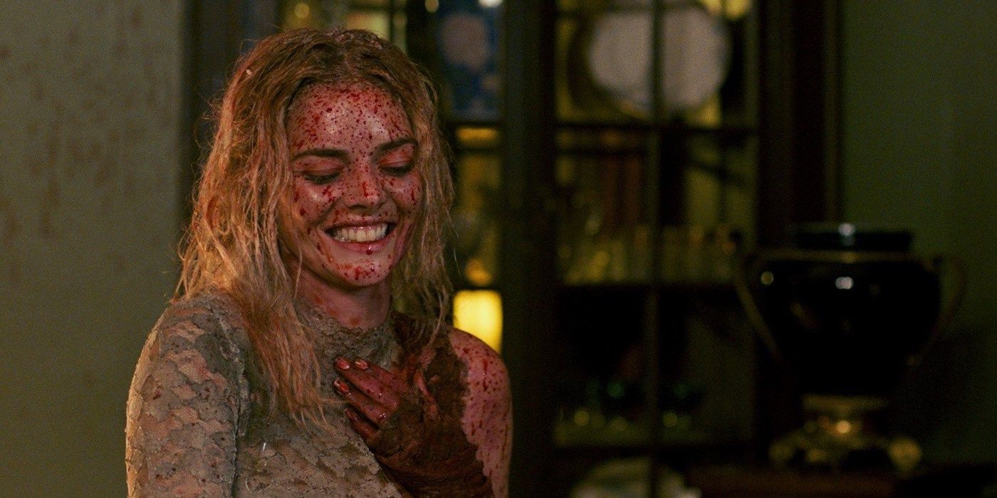 Samara Weaving smiling and covered in blood in Ready or Not.