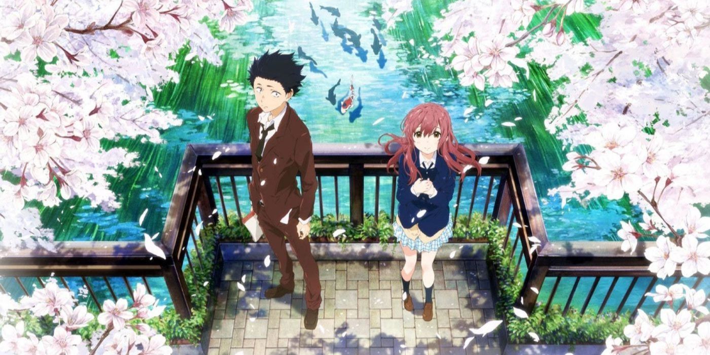 Shoya and Shouko standing on a bridge surrounded by cherry blossoms in A Silent Voice.