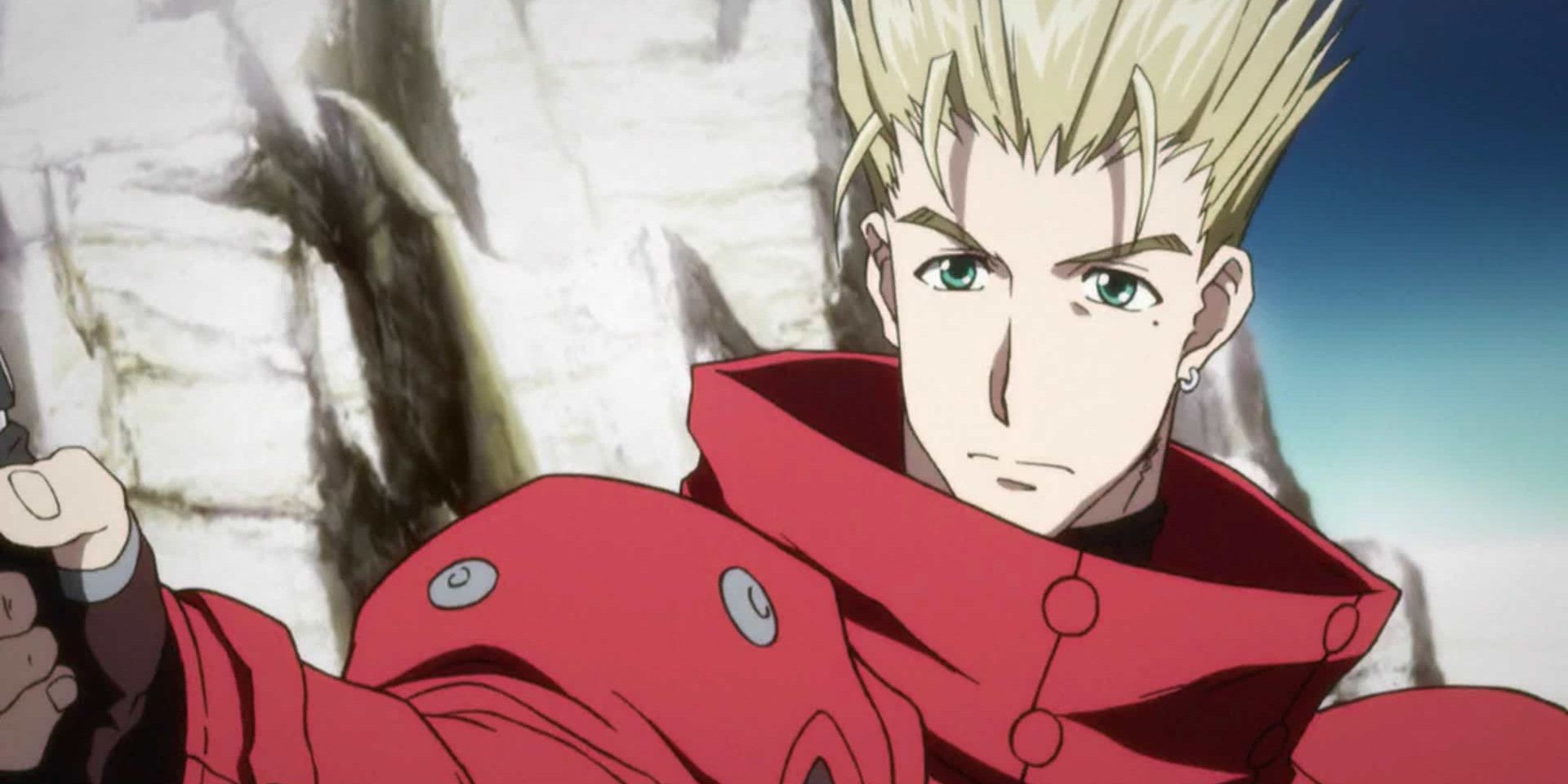 A serious Vash the Stampede holds a gun in Trigun.