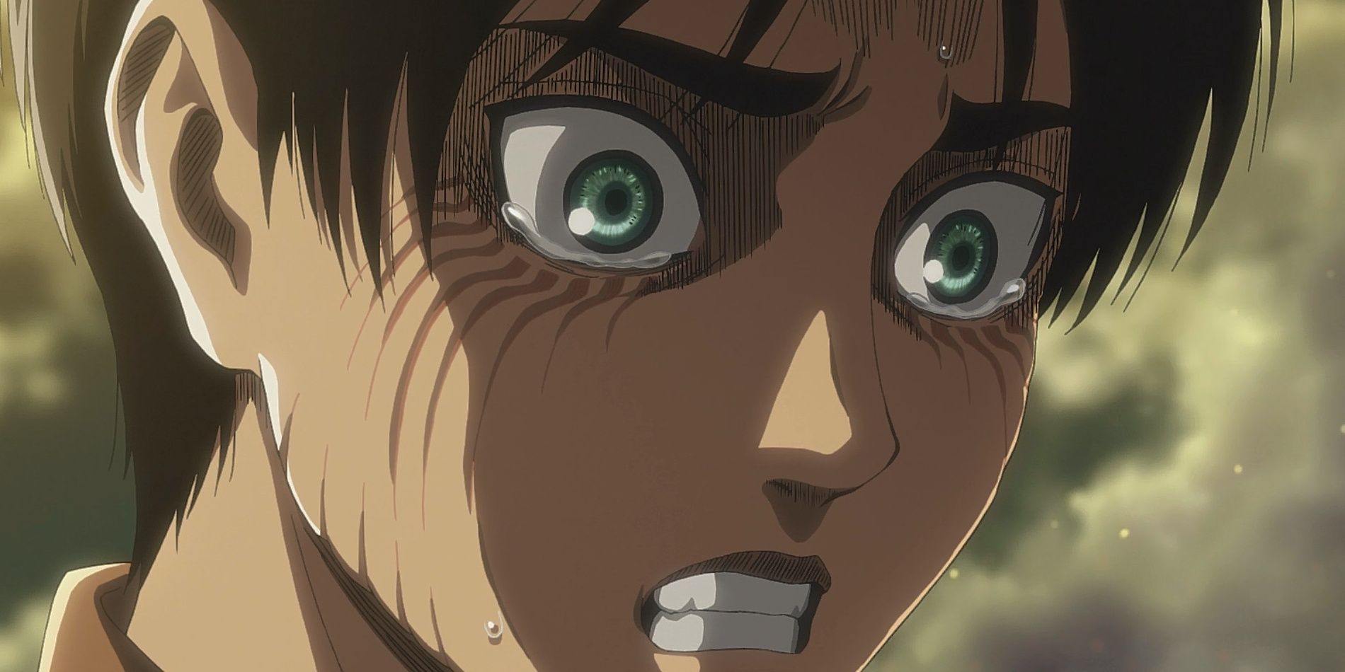 Eren Yeager bares his teeth while starting to cry.
