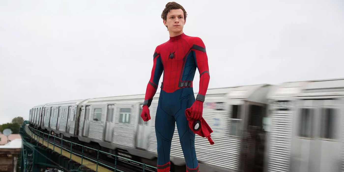 spider-man with his mask off in front of a train