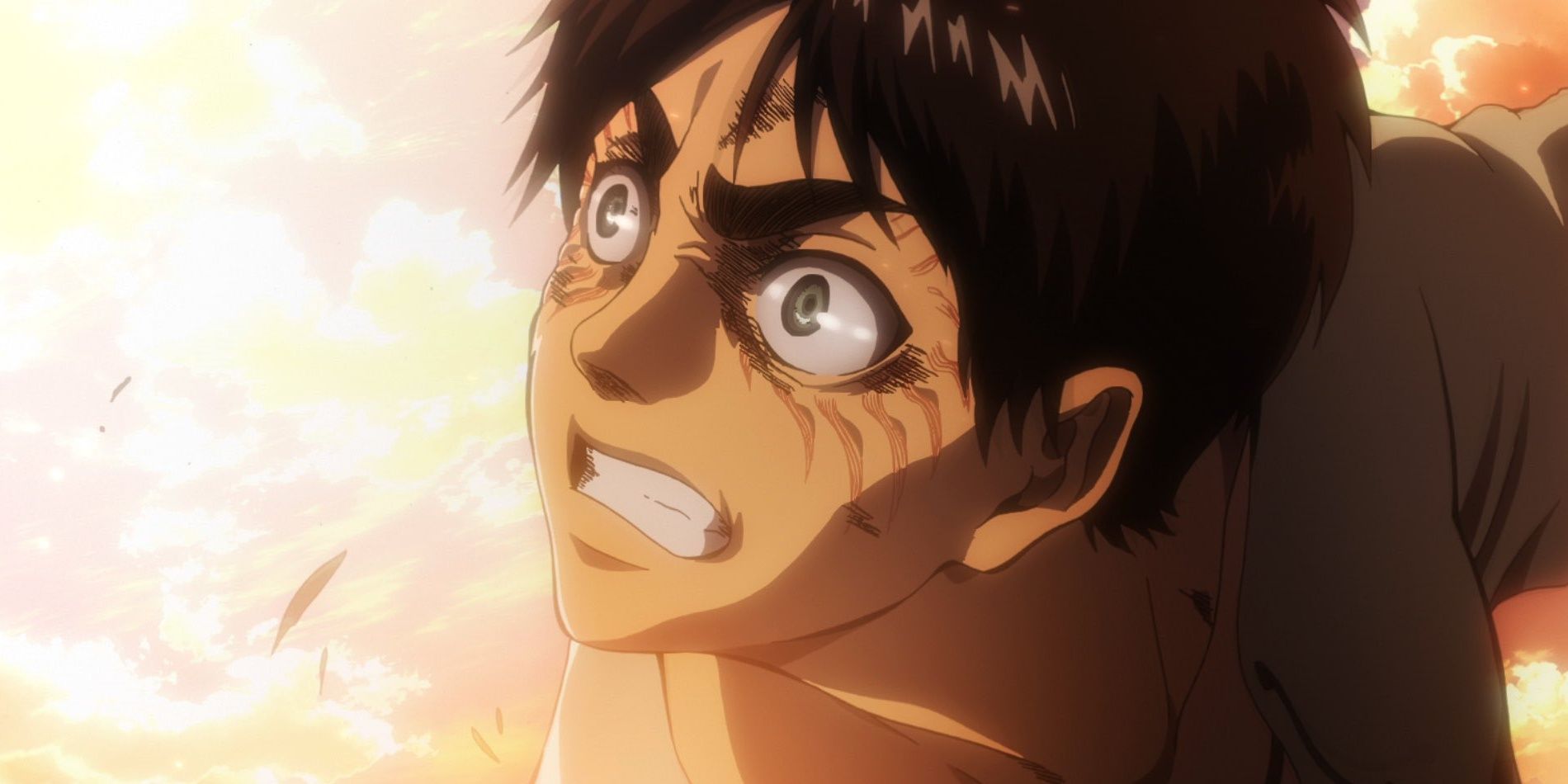 eren yeager bares his teeth as he faces a bright yellow light.