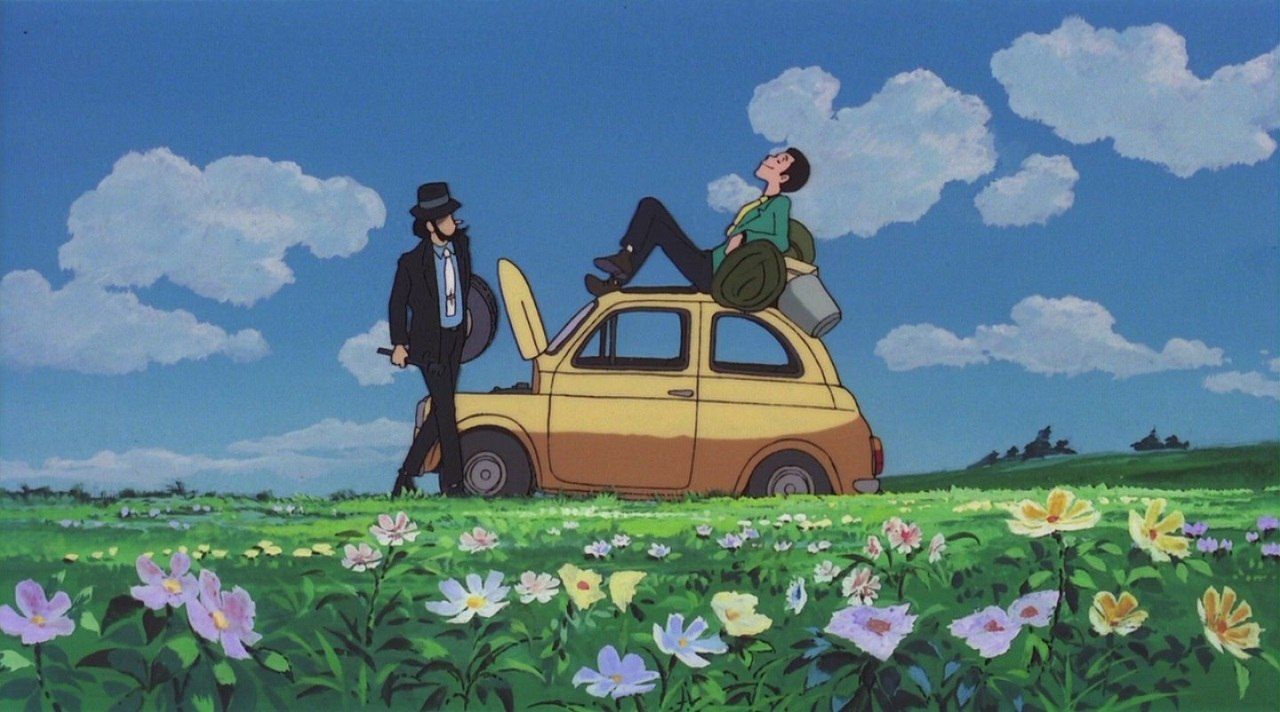 Lupin III sitting on his yellow Fiat 500 while Jigen watches.