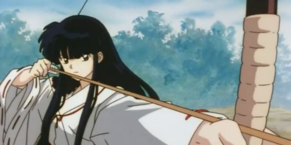 injured kikyo from inuyasha drawing back her bow about to shoot