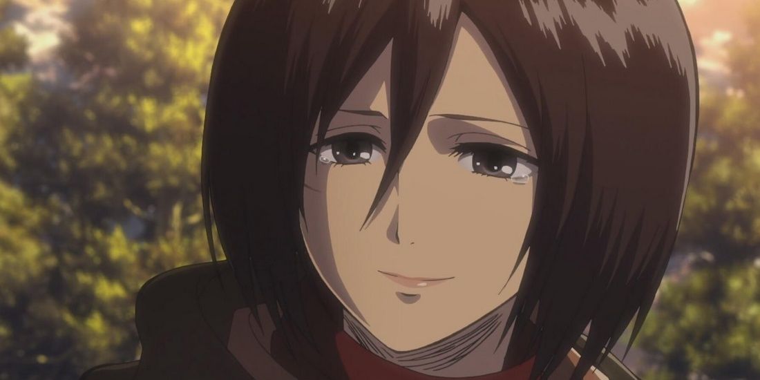 Mikasa Ackerman smiling slightly in Attack on Titan. 