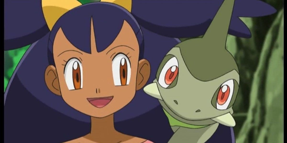 Iris smiling with Axew in Pokémon Journeys.