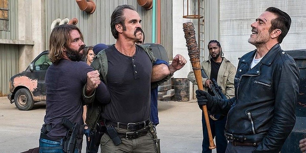 Simon (Steven Ogg) being held back by Saviors in front of Negan (Jeffrey Dean Morgan) on The Walking Dead