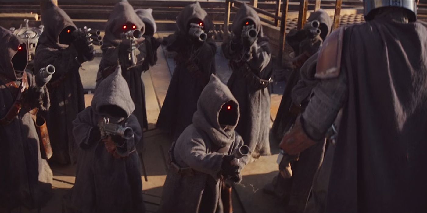 Jawas pointing their weapons at Din