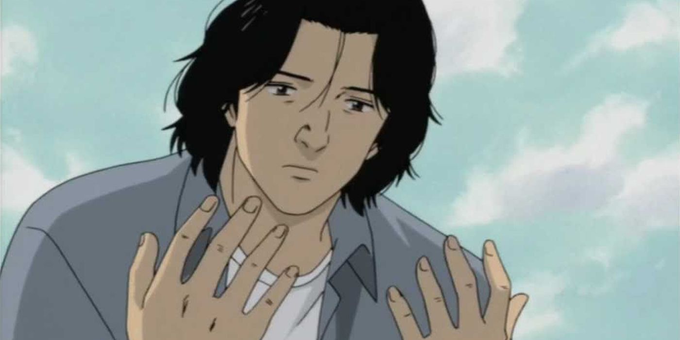 Tenma from Monster looking at his hands.