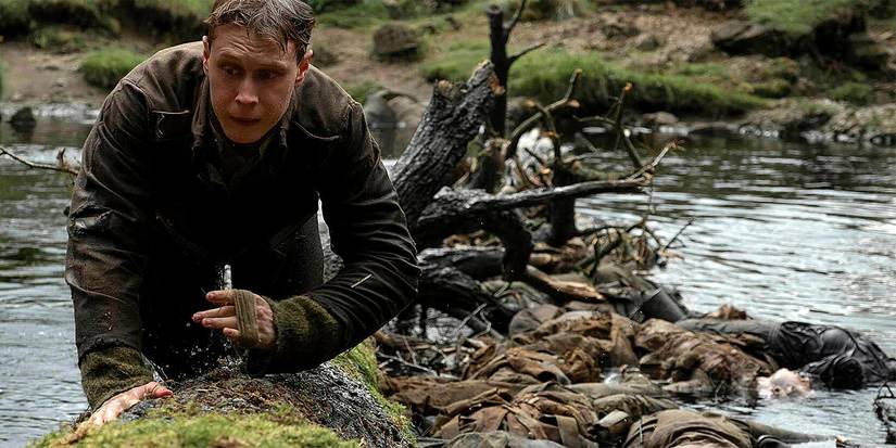 George MacKay turns his back to a river full of corpses in 1917.