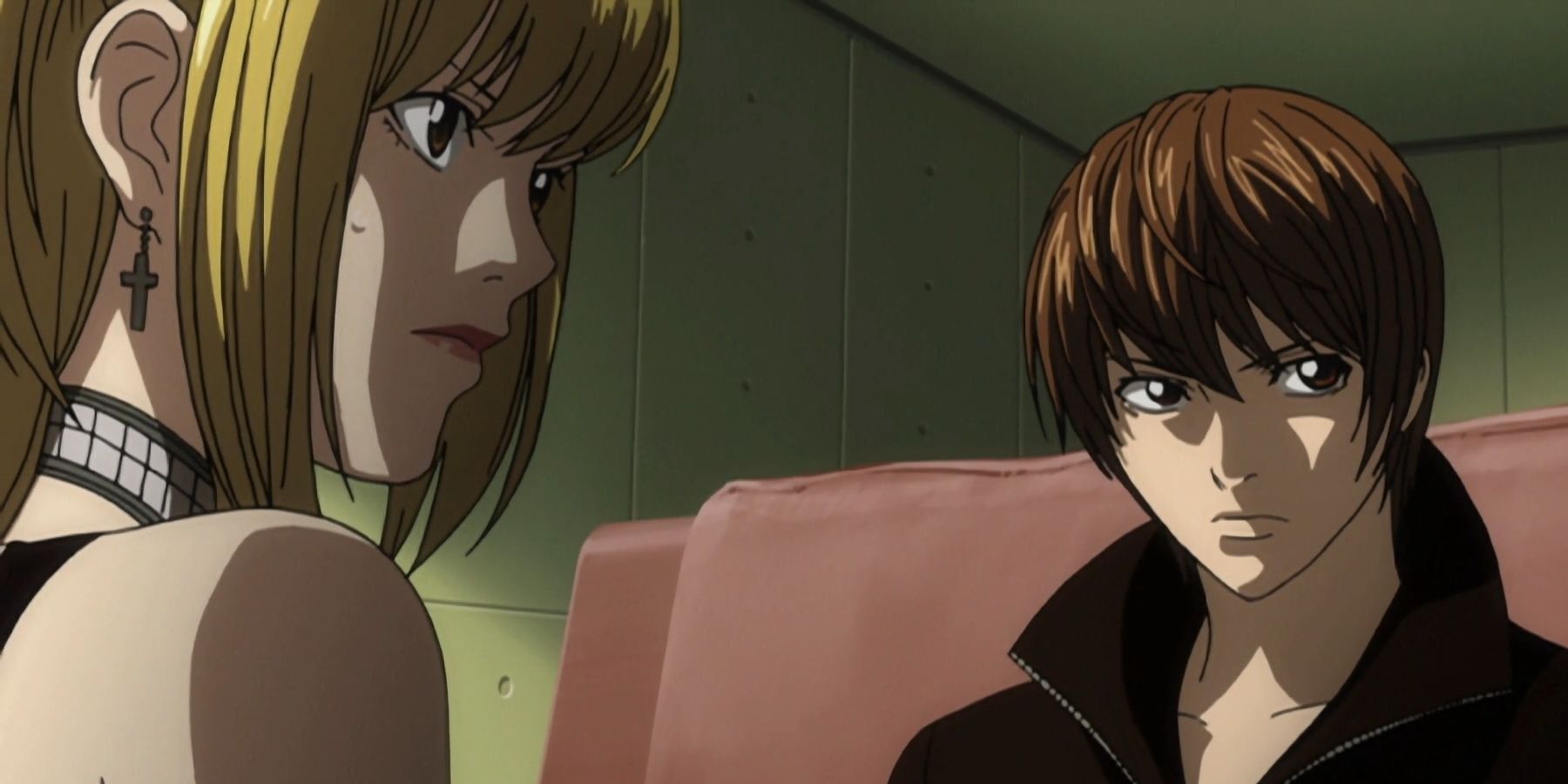 Light and Misa staring off screen in Death Note.