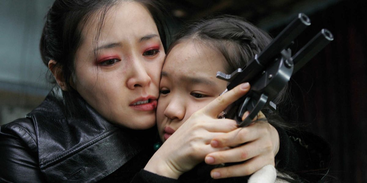 Geum Ja holds a child's face in Lady Vengeance