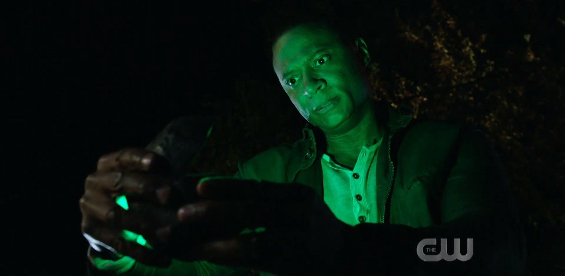 John Diggle looking at a box with a Green Lantern ring inside it.