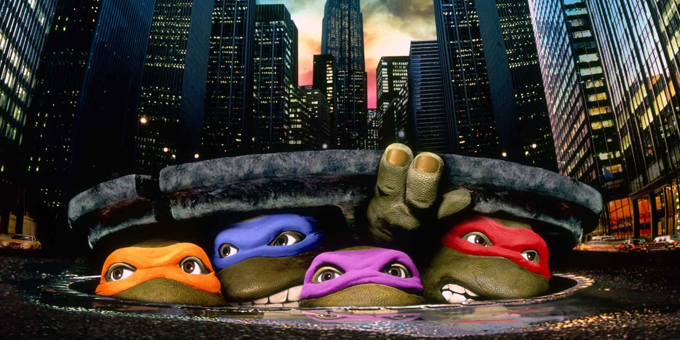 The Teenage Mutant Ninja Turtles peek out of the sewer in the 1990 live action film