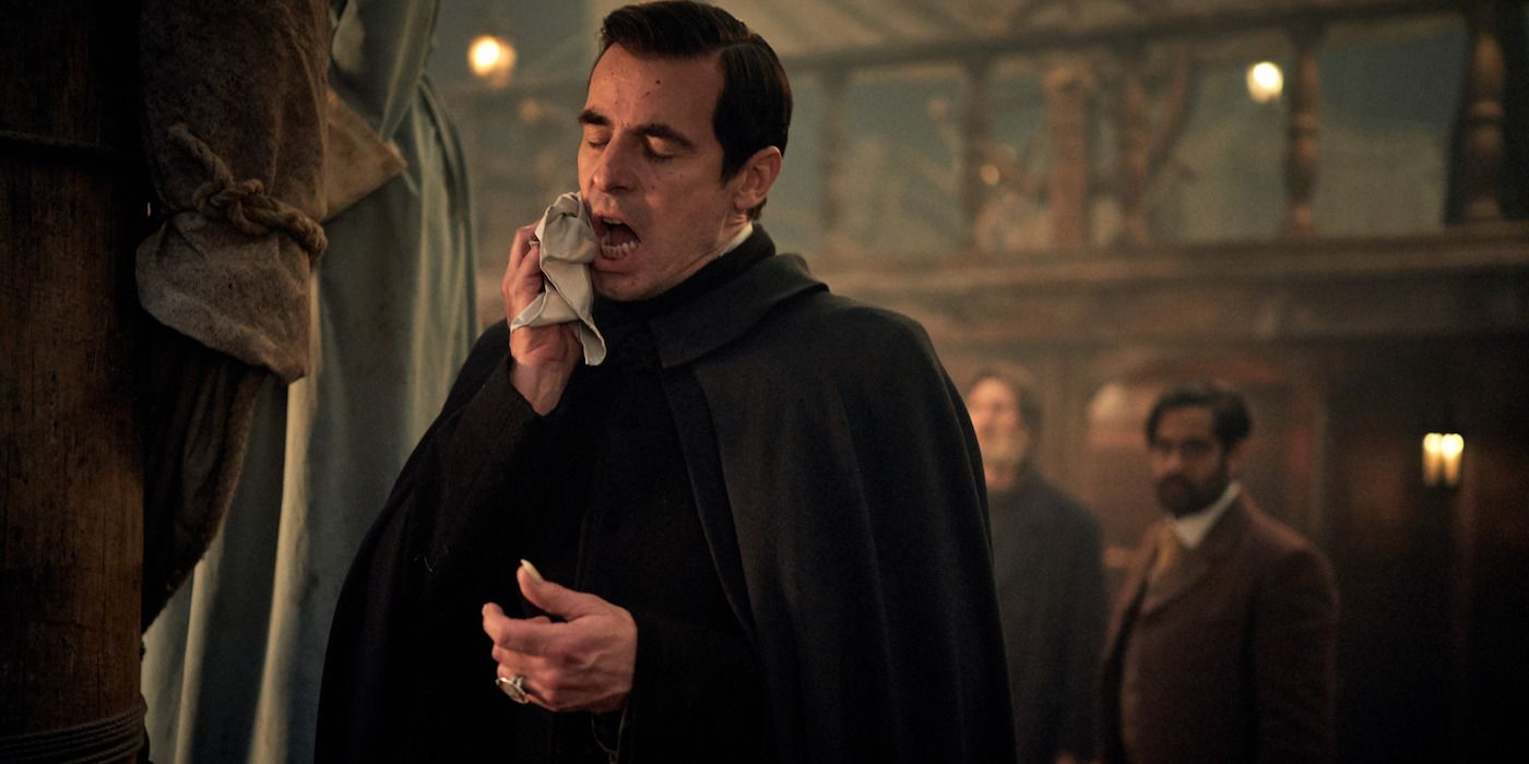 Dracula wipes his mouth with a cloth.