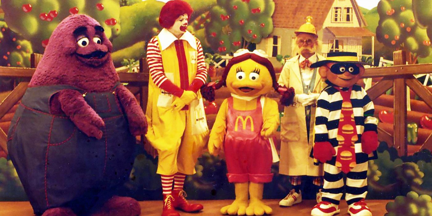 Grimace, Ronald McDonald, Birdie, the Professor and the Hamburglar standing in front of McDonaldland