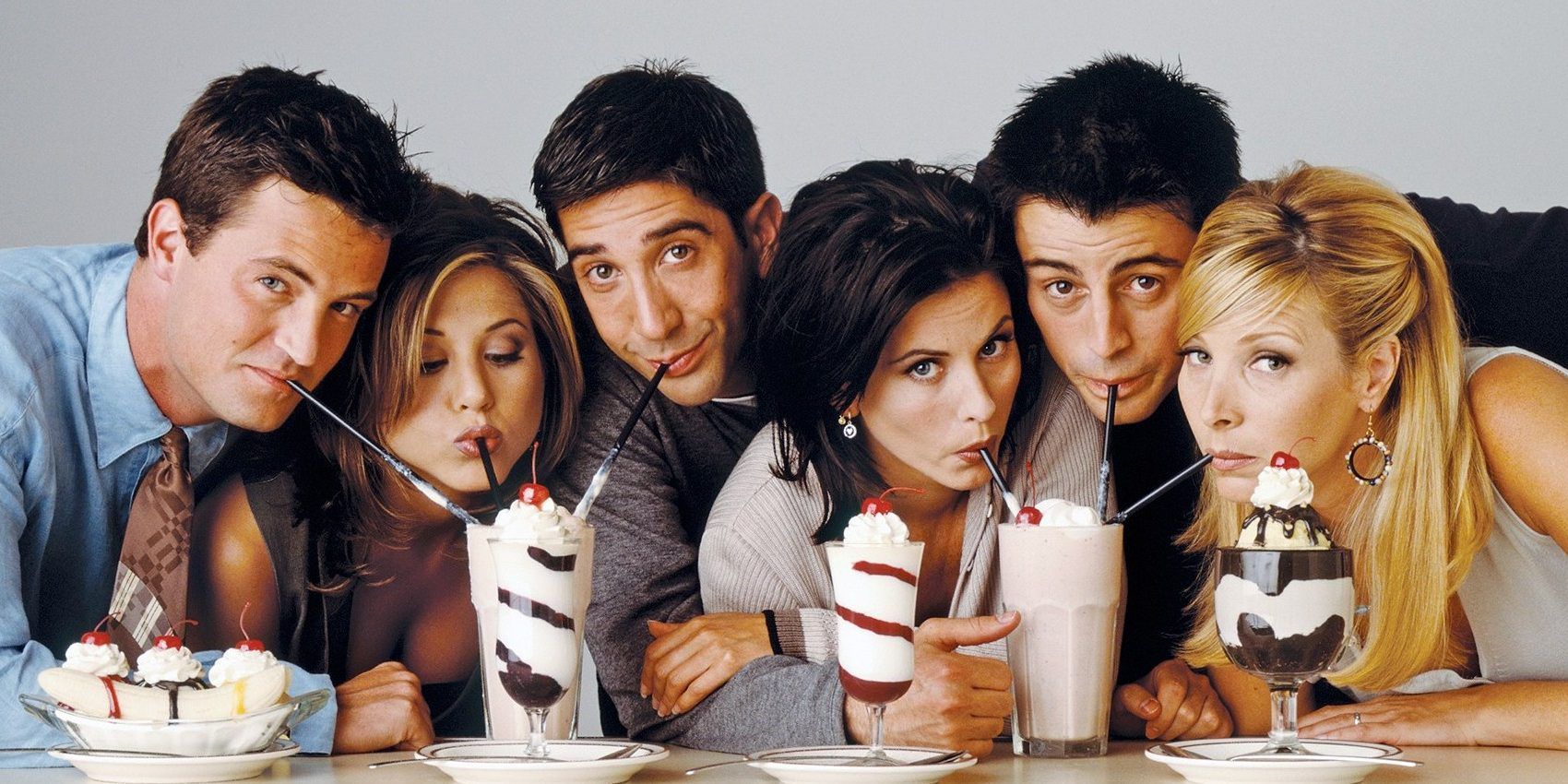 The cast of Friends sipping milkshakes