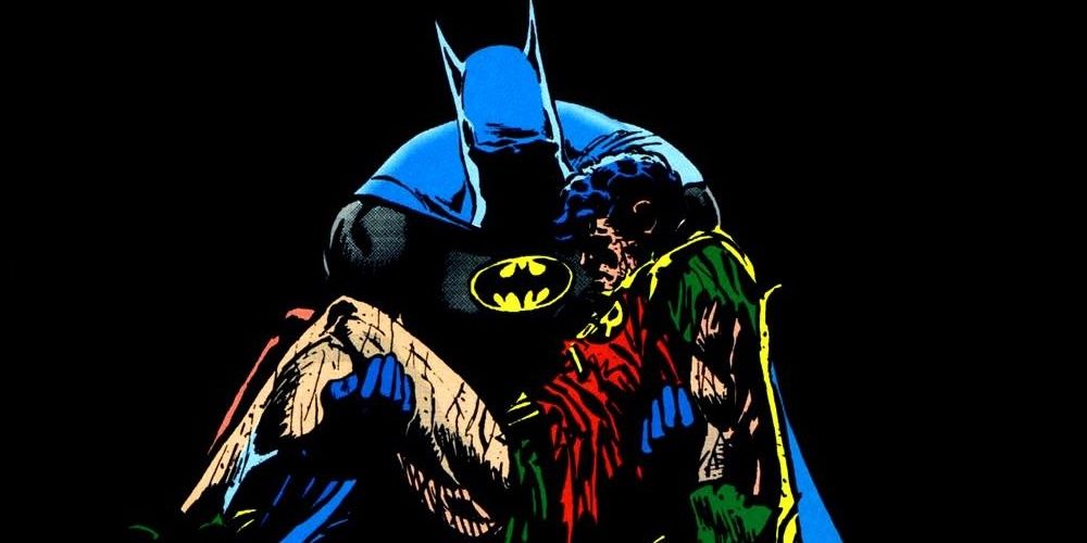 Batman holds a dead Robin