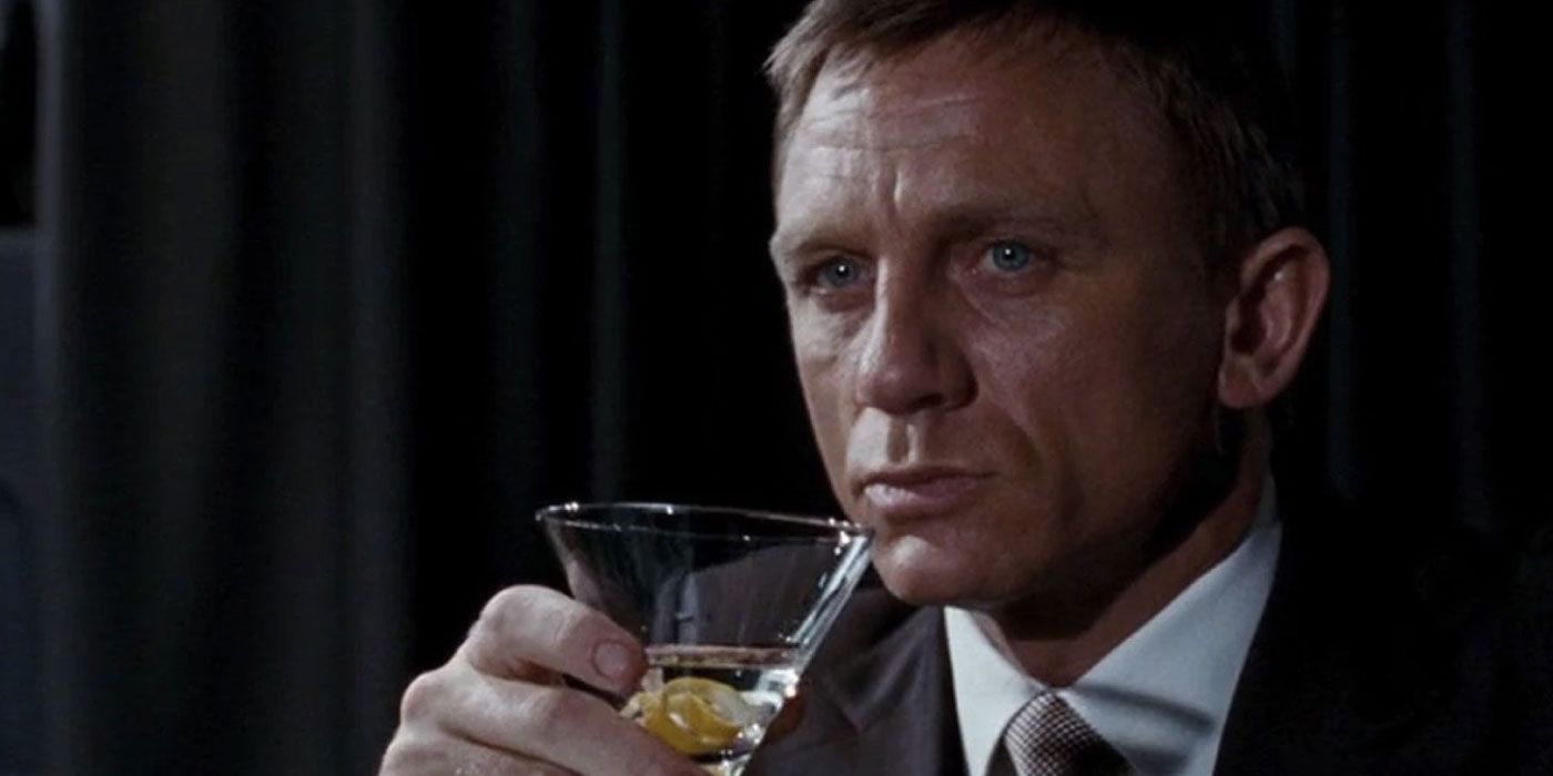 A wary James Bond (Daniel Craig) holds a Martini while sat down