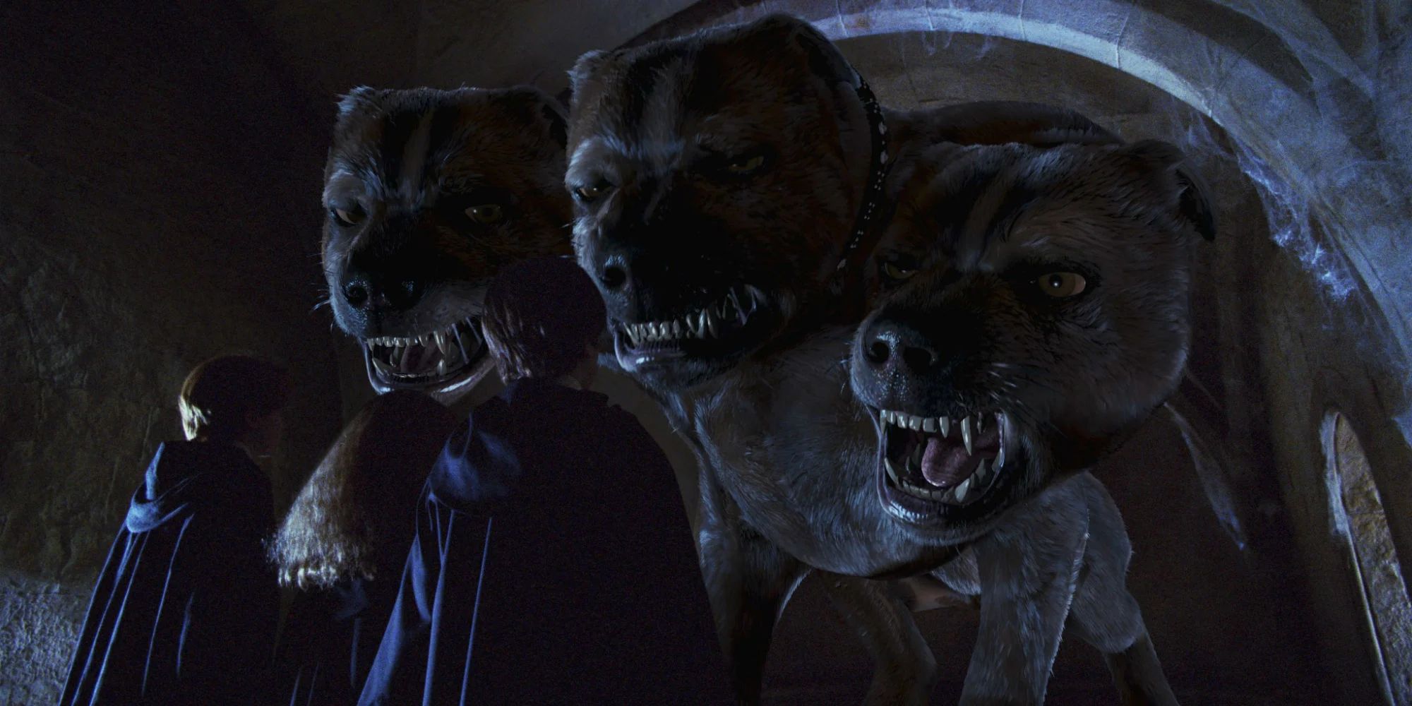 Fluffy the three-headed dog towers above Harry, Ron and Hermione in the Sorcerer's Stone film