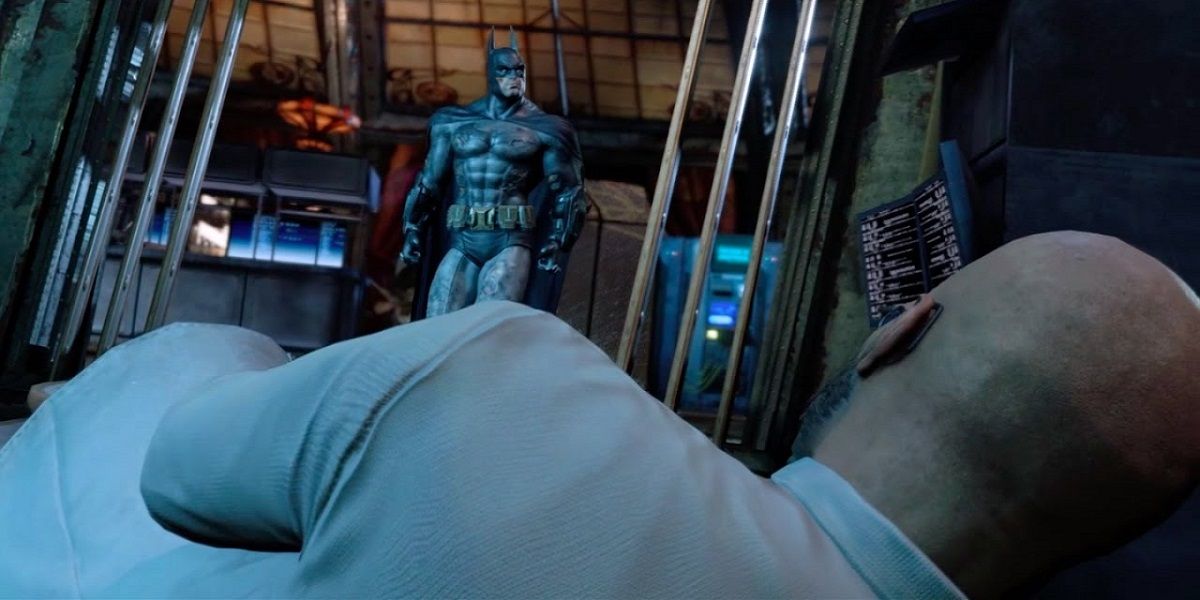 Batman standing in front of a man laying down