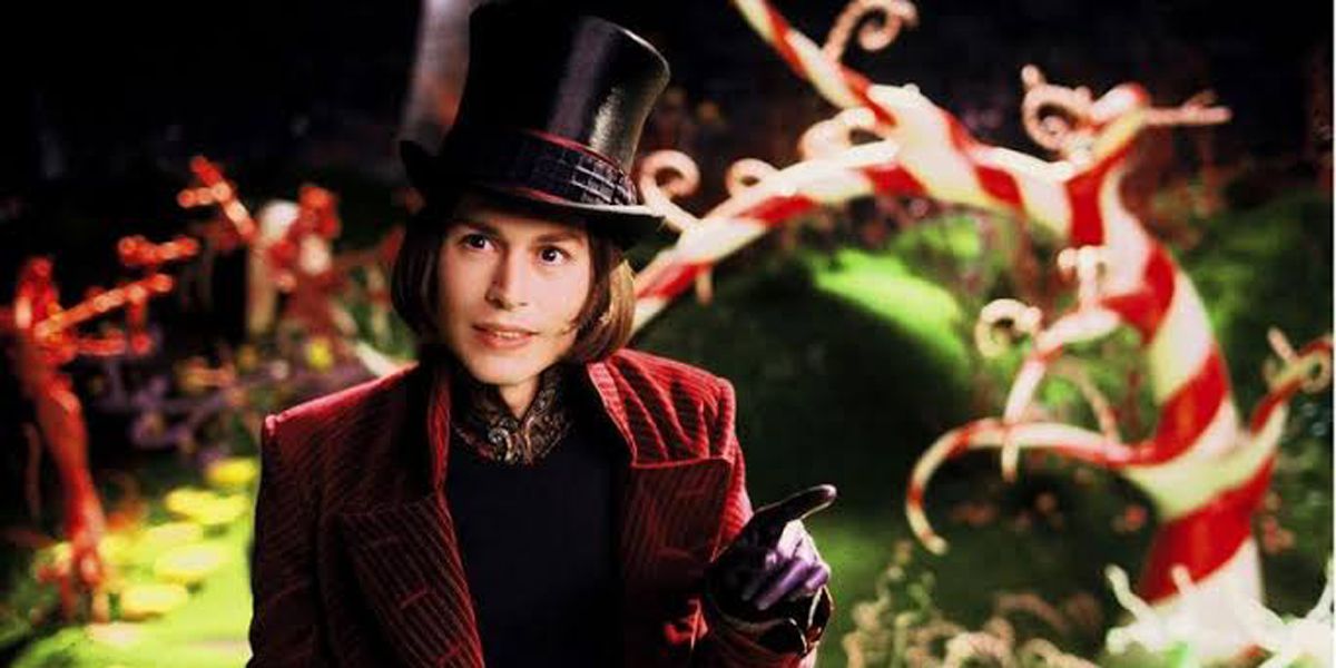 Johnny Depp as Willy Wonka pointing at something in Charlie and the Chocolate Factory