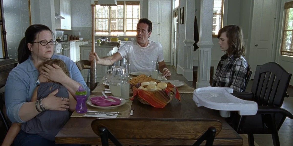 Negan, Olivia, Judith and Carl at the dinner table on The Walking Dead 