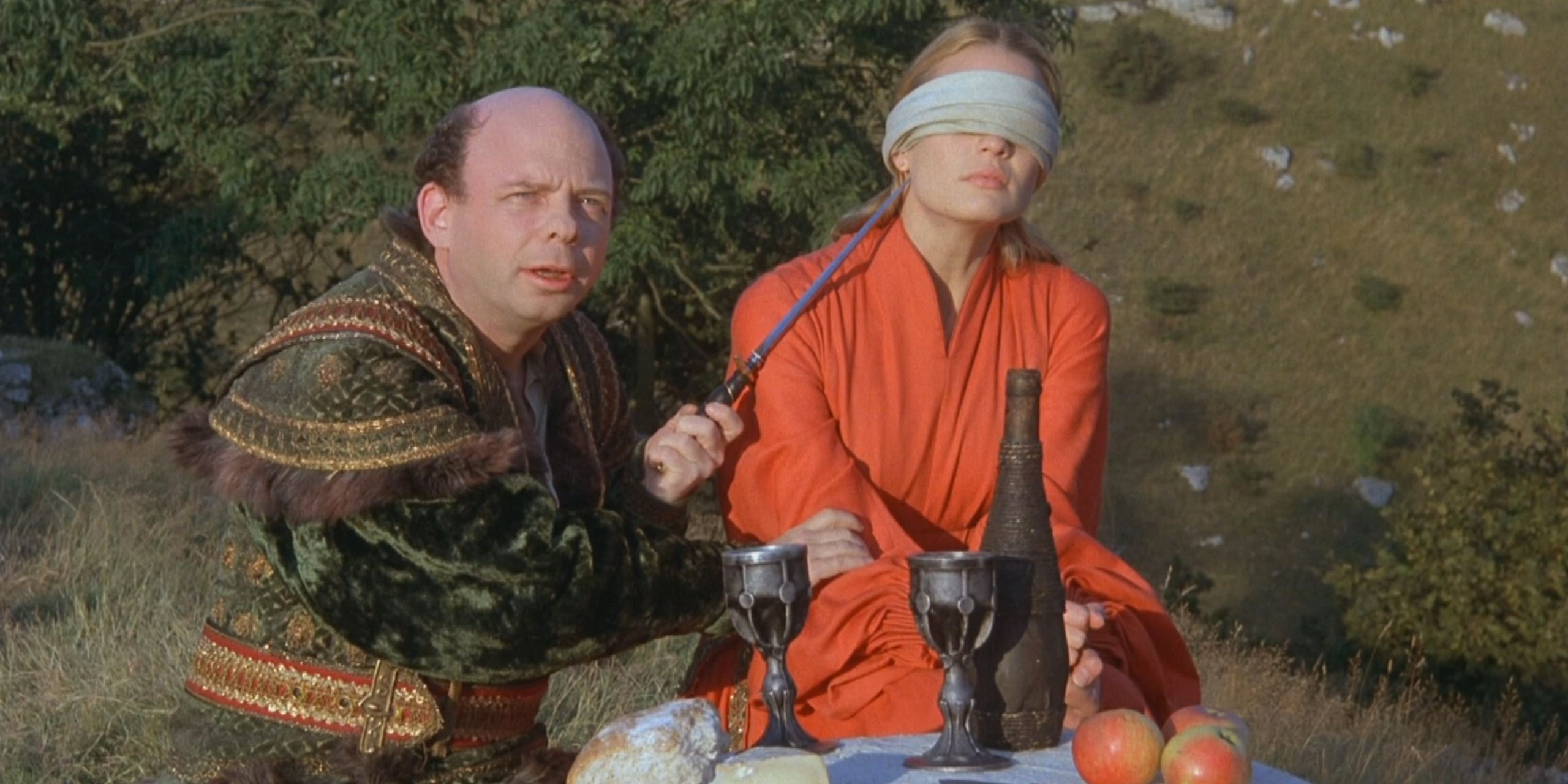 Vizzini from &quot;The Princess Bride,&quot; holding a knife to Buttercup's throat.