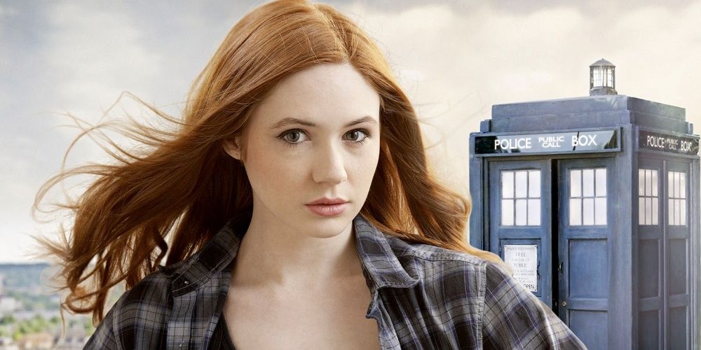 Amy Pond stands in front of the TARDIS in Doctor Who.