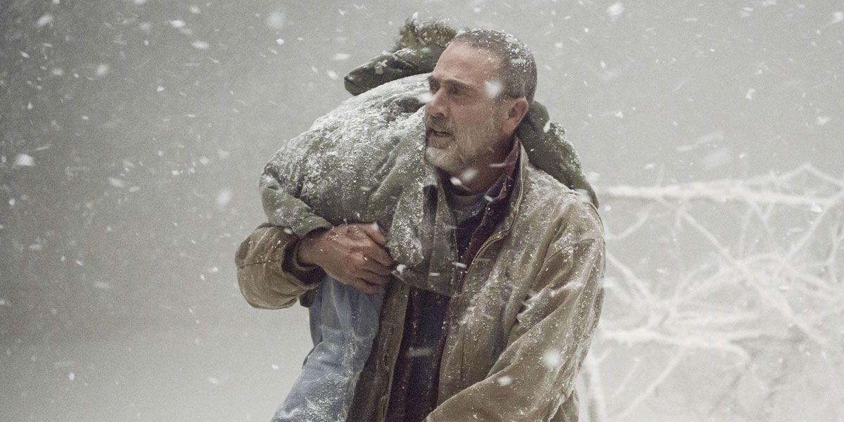 Negan (Jeffrey Dean Morgan) holding Judith during a snowstorm on The Walking Dead