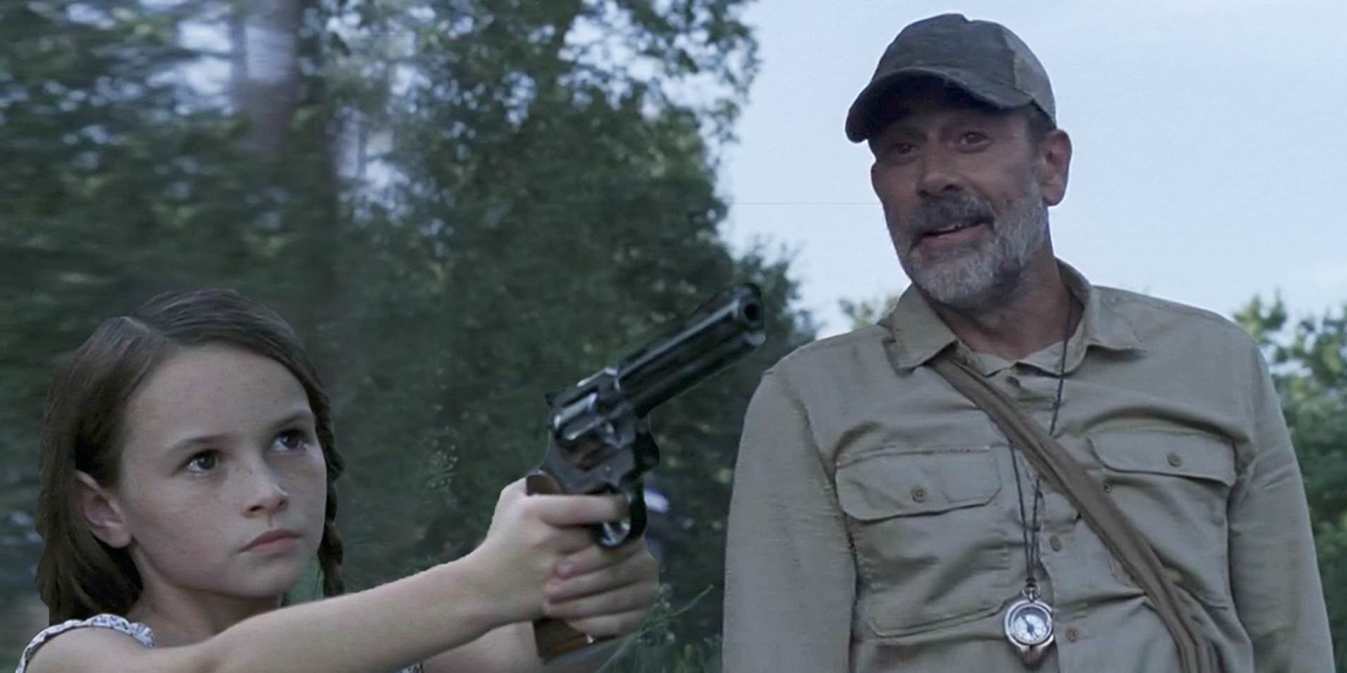Judith (Cailey Fleming) holding a gun to Negan (Jeffrey Dean Morgan) on The Walking Dead