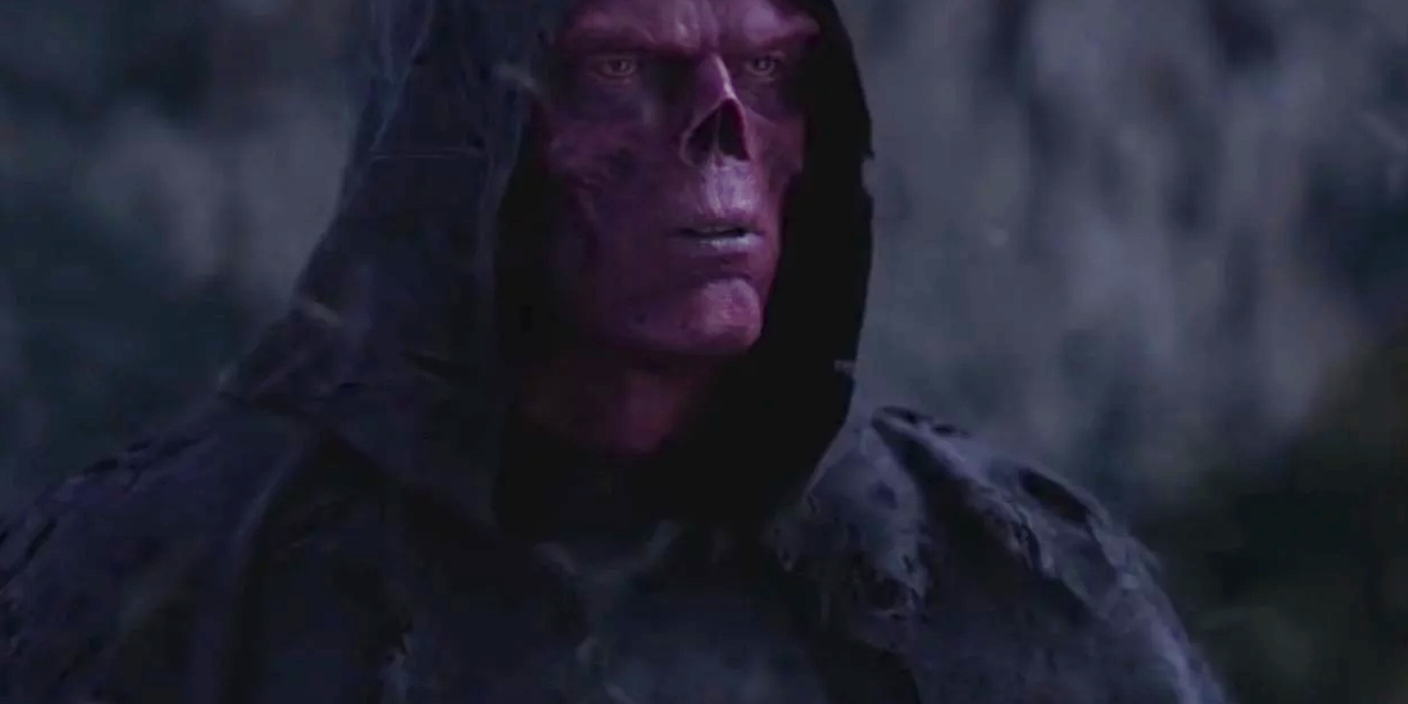 The face of Red Skull looks out from underneath his hood