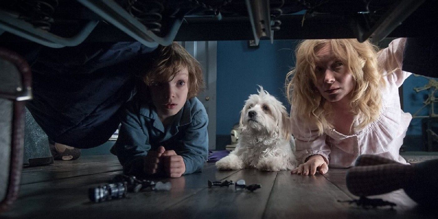 Mom, son and dog looking for monsters under bed in Babadook