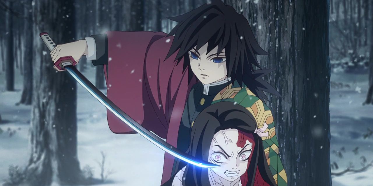 Giyu Tomioka holding his sword in front of Nezuko in Demon Slayer.