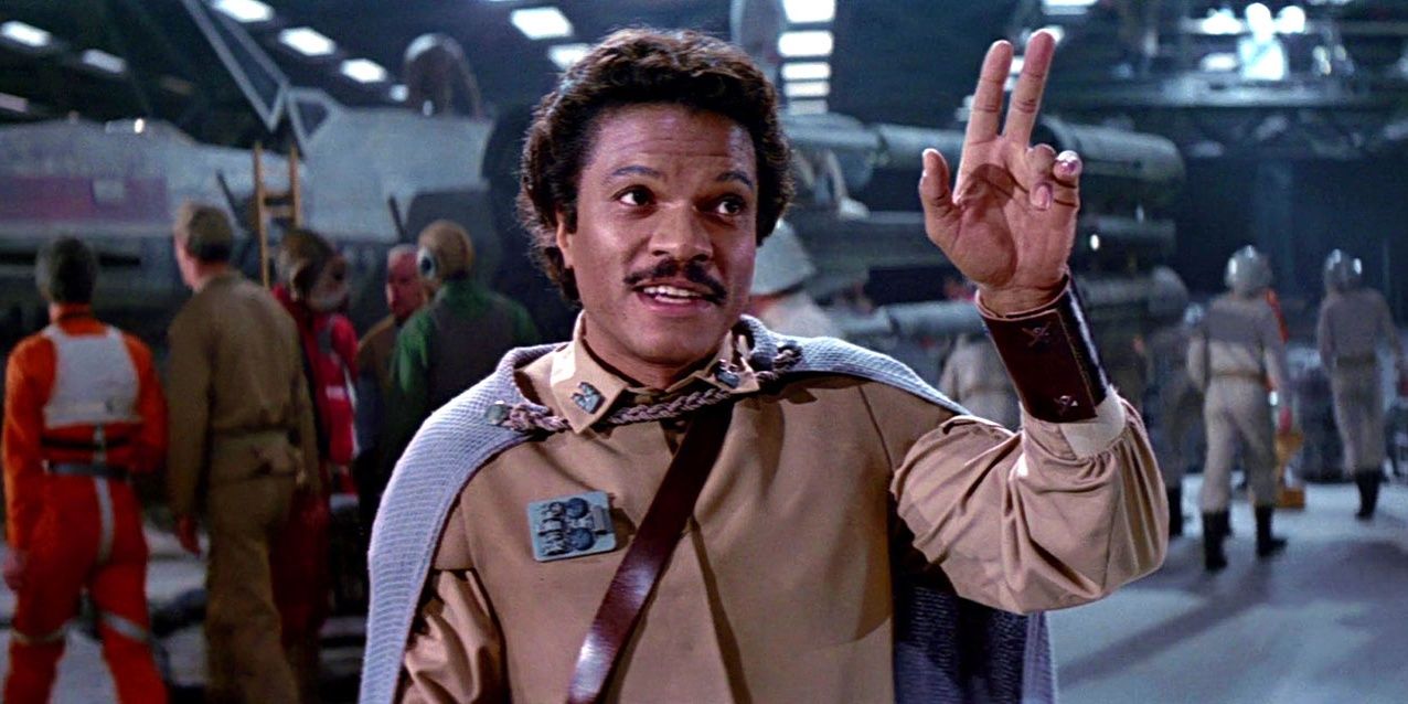Lando Calrissian holds up his hand and smiles