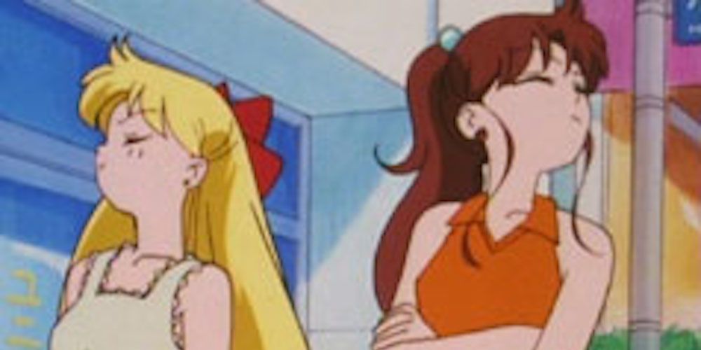 Minako and Makoto from Sailor Moon looking angrily away from each other