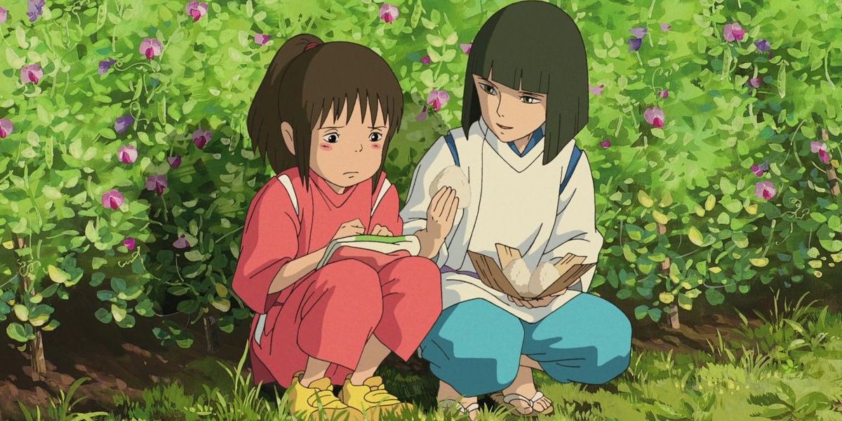 Chihiro and Haku sitting together in the flower garden in Spirited Away.