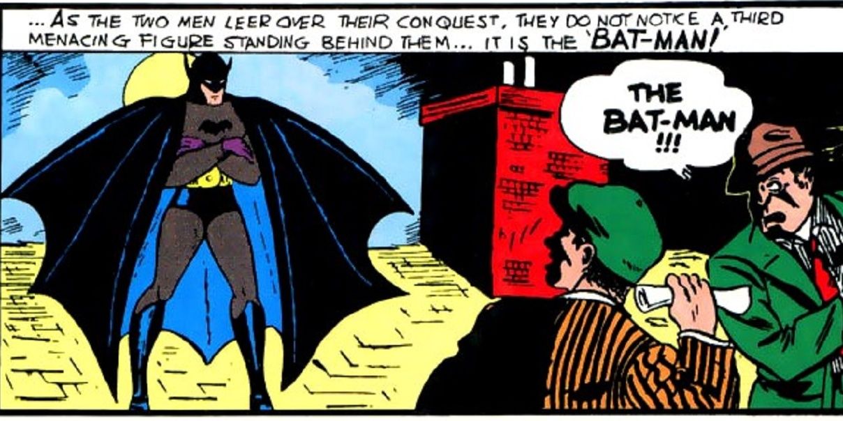 Batman's debut on a rooftop, threatening criminals